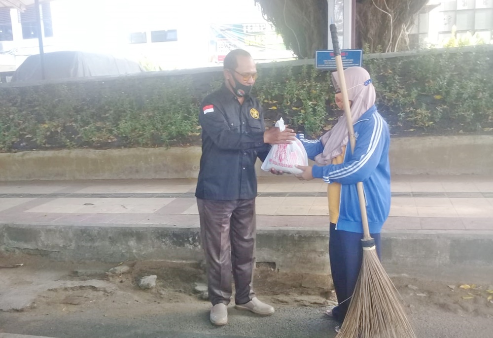 Anggota lsm gagak hitam saat bagikan sembako di tukang pesapon jalanan