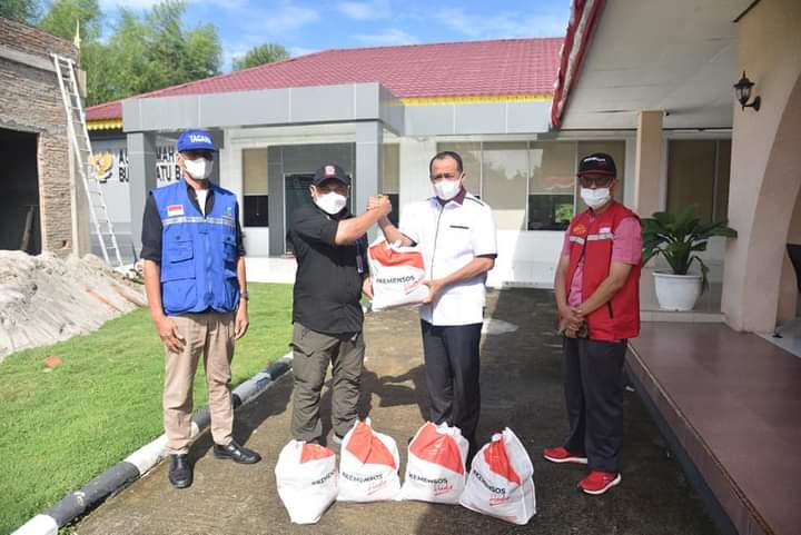Perwakilan Kemensos RI, Muhammad Delmi dari Kasubdit Penanganan dan Korban Bencana Alam saat menyalurkan paket sembako secara simbolis kepada Pemkab Batubara.