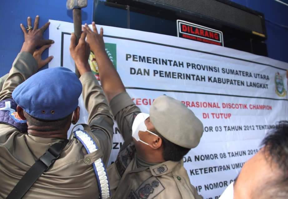 Petugas Satpol PP menyegel usaha diskotik Blue Star di Tanah Seribu, Desa Kwala Mencirim
