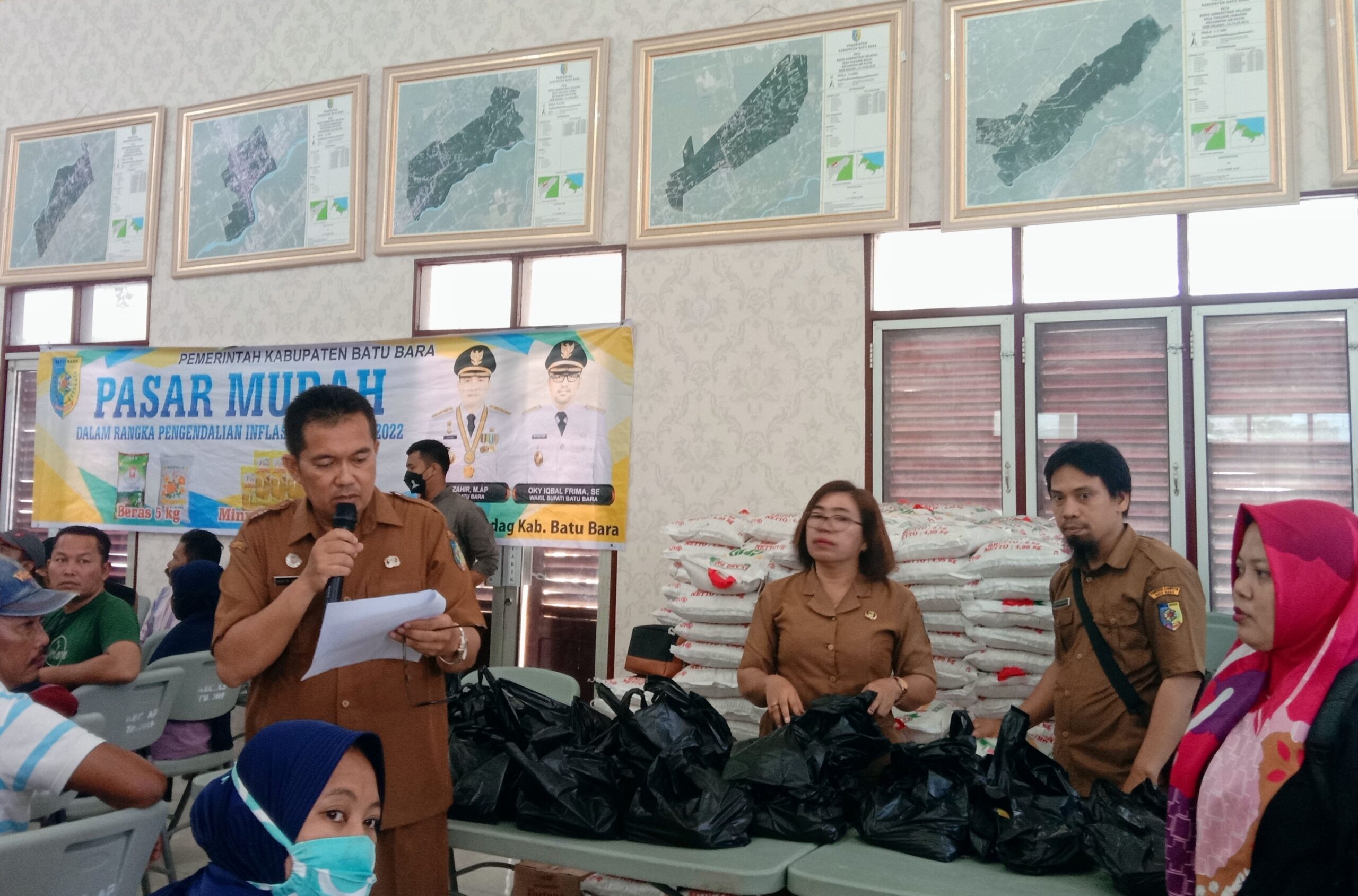 Kabid Perdagangan Disnaker Perindag Sahat Tampubolon saat menyalurkan sembako Pasar murah Pemkab Batubara di Aula Kantor Camat Kecamatan Air Putih. (FTR)